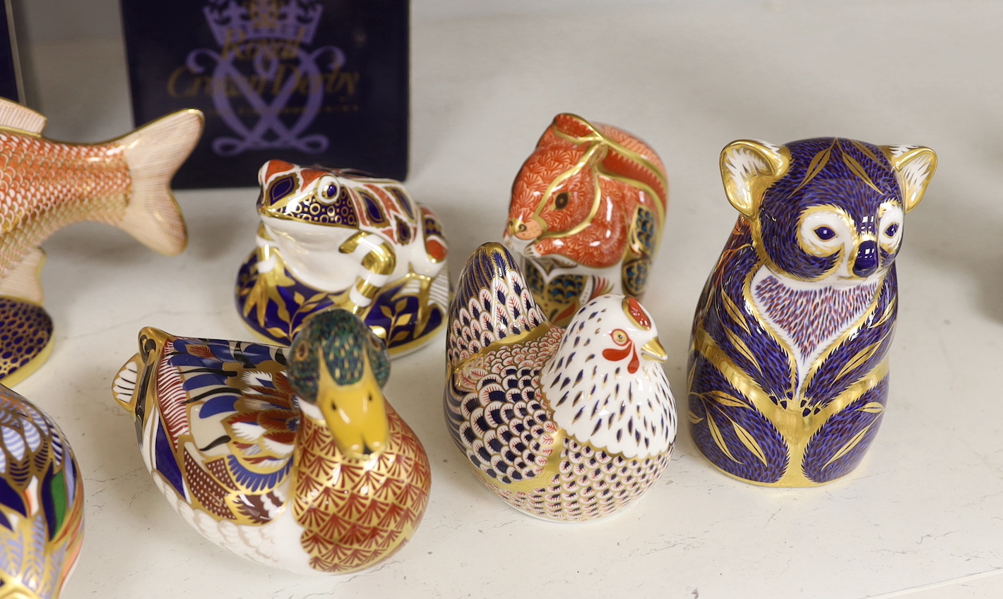 A collection of nine Royal Crown Derby paperweights